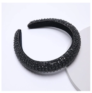 Macro view of wide velvet headband with rows of hand-set sparkling black rhinestones