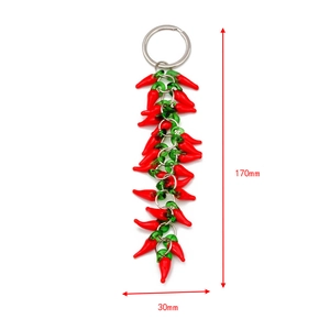 Detail view of a 170mm red chili pepper charm keychain with silver metal ring