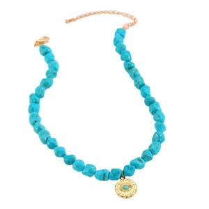 Bohemian turquoise beaded necklace with gold Evil Eye pendant on a white background