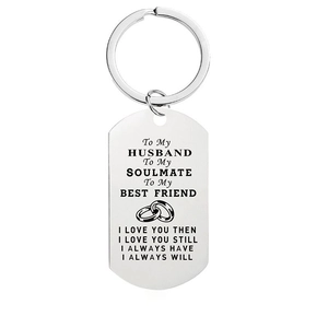 Close-up of engraved stainless steel dog tag keychain with romantic love quotes
