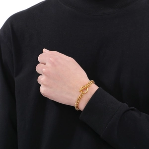 Men's gold dragon bone chain bracelet with OT toggle clasp on a male model's wrist