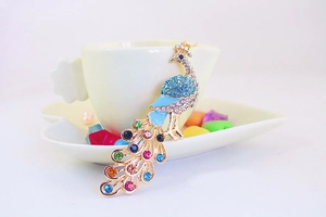 Macro shot of colorful rhinestone peacock keychain with vibrant blue enamel details