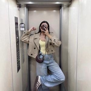 Short khaki double-breasted trench coat with wide lapels and loose casual style