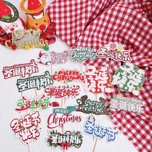 Merry Christmas paper cake toppers with Santa and reindeer on red plaid background