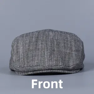 Front view showing the detailed grey herringbone weave texture of this vintage flat cap