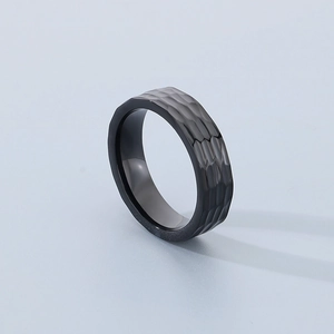Detail shot of black stainless steel ring featuring a unique hammered textured finish