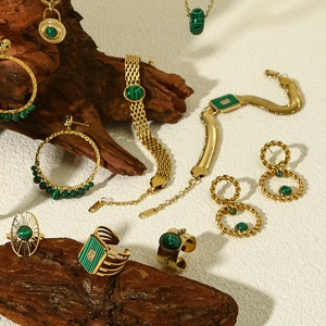 Luxury 18k gold plated jewelry set with green natural stones on rustic wood base