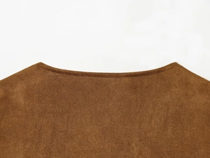 Close-up of brown suede jacket neckline showing fine stitching and soft fabric texture