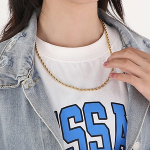 Detail of 18k gold plated stainless steel twist rope chain necklace on female model