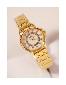 Close-up of gold flower watch with mother of pearl dial and sparkling rhinestones