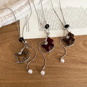 Retro rocking horse pendant necklace with zircon and pearls in mustard, burgundy, and brown