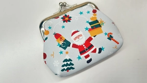 Detail of Christmas coin purse with vintage metal clasp and festive Santa Claus print
