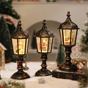 Three vintage gold Christmas lanterns with snowmen, Santa, and nativity scene liquid glitter