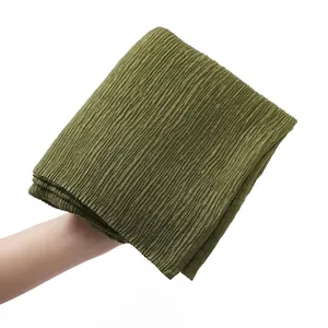 Detail shot of olive green cotton linen scarf showing high-density pleated texture