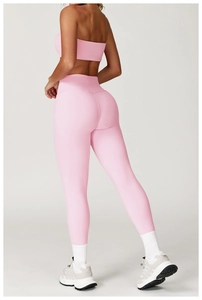 Detail view of pink yoga set featuring high-waist lifting leggings and sports bra