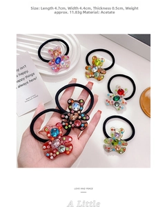 Detail of bear hair tie with colorful rhinestones and acetate material, 4.7x4.4cm size