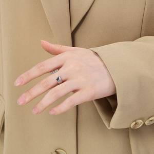 Polished silver stainless steel open ring shown on hand with minimalist professional style