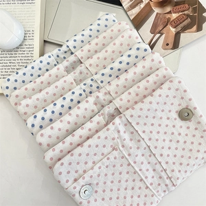 Detailed view of polka dot cotton passport cover with magnetic snap closure and texture