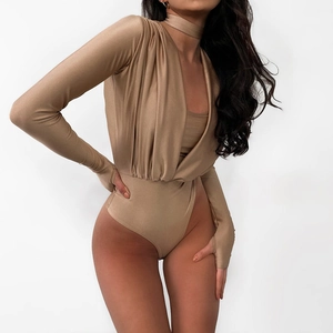 Detail of beige V-neck pleated bodysuit featuring long sleeves and matching neck choker accessory