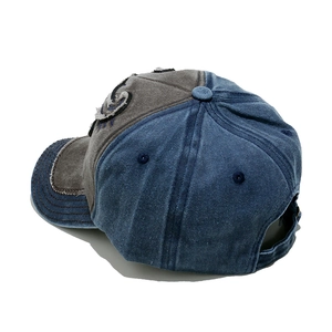 Detail of vintage washed canvas baseball cap featuring side embroidery and adjustable strap