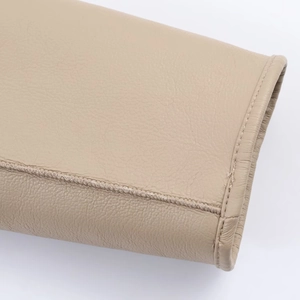 Close-up of premium beige faux shearling jacket showing leather texture and stitching