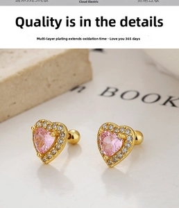 Detail of S925 sterling silver heart earrings with pink zircon and gold plated finish
