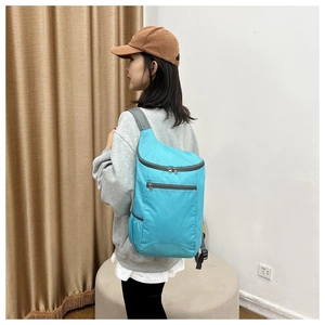 Detail view of the breathable mesh shoulder straps on the blue outdoor folding backpack