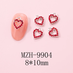 Detail of red rhinestone heart nail charms with silver metal frames for Y2K manicure