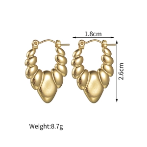 Detail view of gold croissant earrings with dimensions 1.8cm by 2.6cm and 8.7g weight
