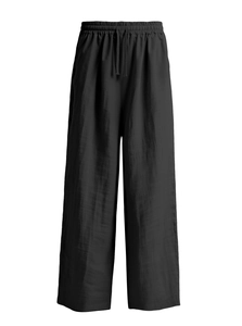 Detailed macro shot of black cotton linen pants with elastic waist and drawstring detail