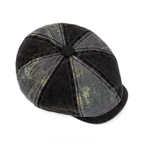 Top view of patchwork denim newsboy cap in dark black and faded grey-blue colors