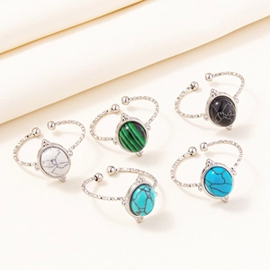 Detail view of five adjustable 304 stainless steel rings with colorful oval stone inlays