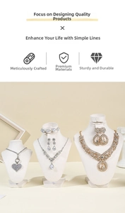 Detailed display of silver heart and teardrop necklaces on velvet bust stands