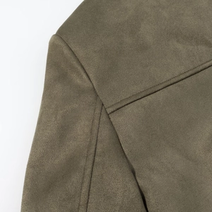 Close-up of olive green suede blazer showing high-quality double-stitched shoulder seams