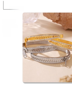 Close-up of gold and silver zipper-style bracelets with sparkling full crystal pavé