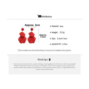 Detail view of red floral petal drop earrings with silver needle specs and 15.2g weight