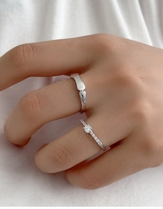 Detail of silver bamboo style ring with micro-set zircon on woman finger