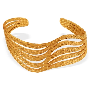 Elegant gold-tone open cuff bracelet featuring a minimalist multilayer wave line design