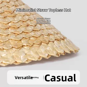 Macro shot showing the detailed hand-woven wheat straw texture of the sun visor hat