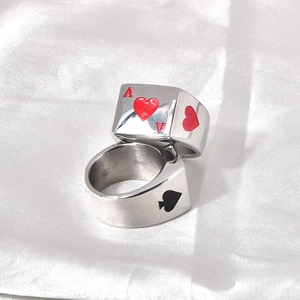 Detail of silver titanium steel rings featuring Ace of Hearts and Ace of Spades poker designs