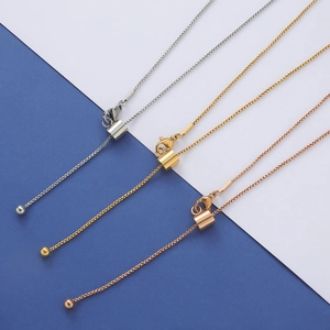 Detail of adjustable geometric box chains in silver, gold, and rose gold with bead charms
