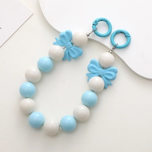 Close-up of blue and white acrylic beaded chain with a bow and dual lobster clasps