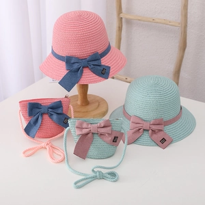 Detail of pink and mint green straw hats and matching bags with large bowknot decor