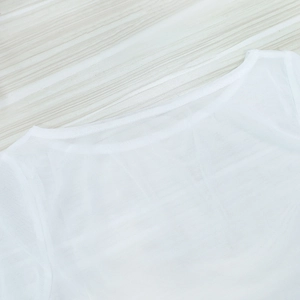 Detailed view of the sheer white mesh fabric and delicate crew neckline stitching