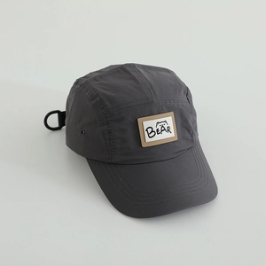 Detail of dark grey quick-dry five-panel cap with Bear patch and adjustable D-ring