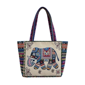 Detailed close-up of intricate elephant and floral embroidery on ethnic canvas tote bag