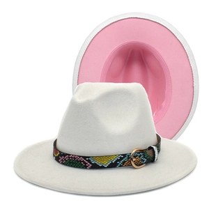 Detailed view of white fedora hat with pink brim contrast and snakeskin textured band