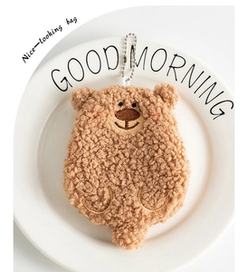 Detailed view of the soft teddy fleece brown bear coin purse with fine embroidery details