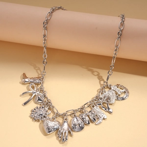 Detailed silver western charms including cowboy boots, hearts, and hats on a sleek chain