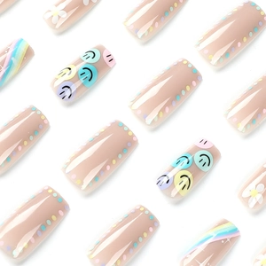 Press-on nails featuring five-color smiley faces, white flowers and rainbow stripes